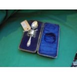 Boxed silver christening spoon (London 1907) and an ornate napkin ring (Chester 1904)