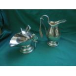 Matching pair of early 20th century plated cream jug and helmet sugar basin with dredger each with