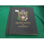 Stamp album marked United States of America some pages containing original stamps of different eras