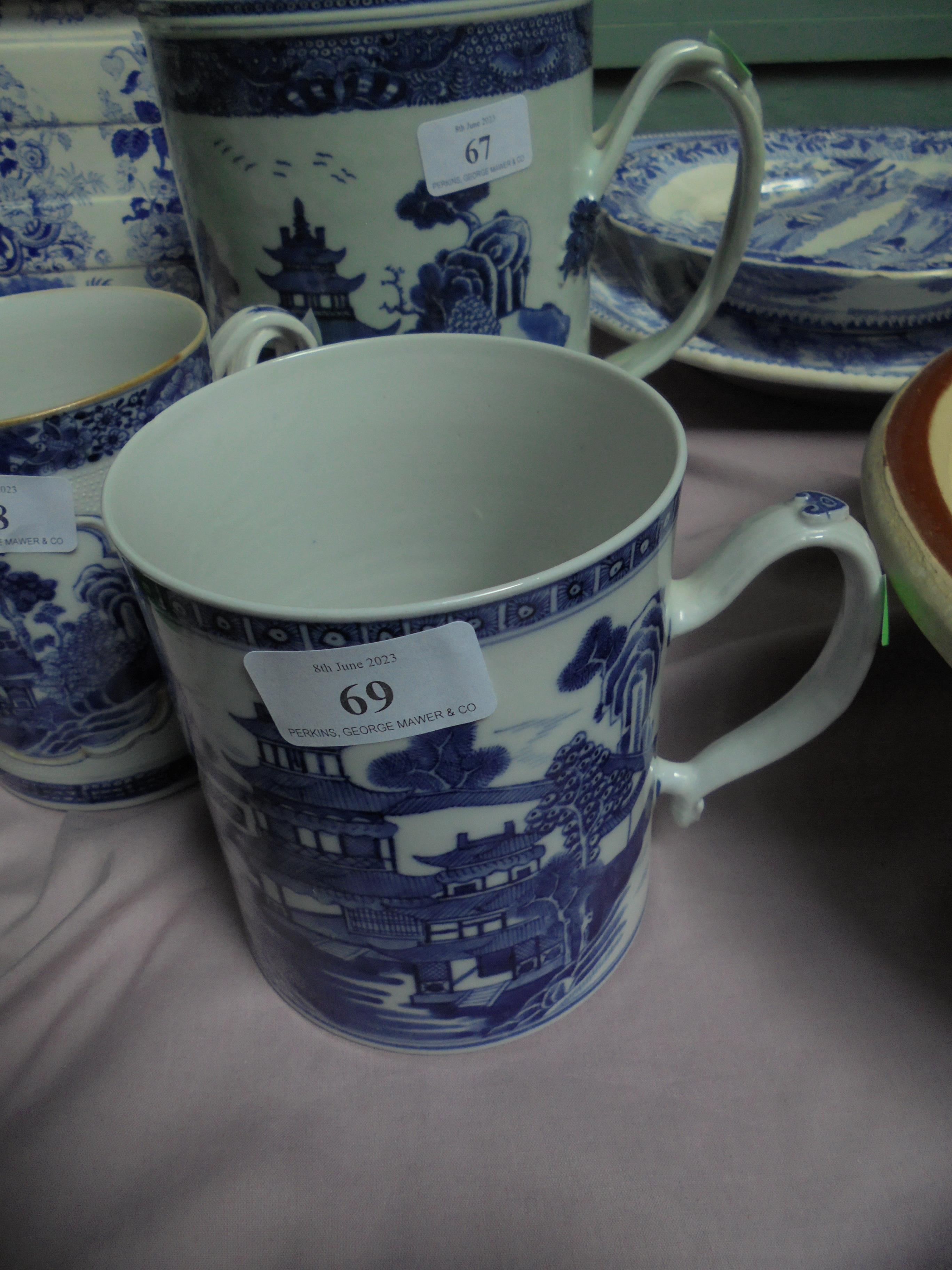 Chinese blue and white mug of 19th century origin showing village scene with pagodas,