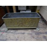 Sizeable brass planter with lion head handles and paw feet with original lead liner