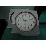 2 kitchen wall clocks in boxes and bird feeder on stand in box