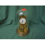 Glass domed table clock in brass on metal style base possible 1930's