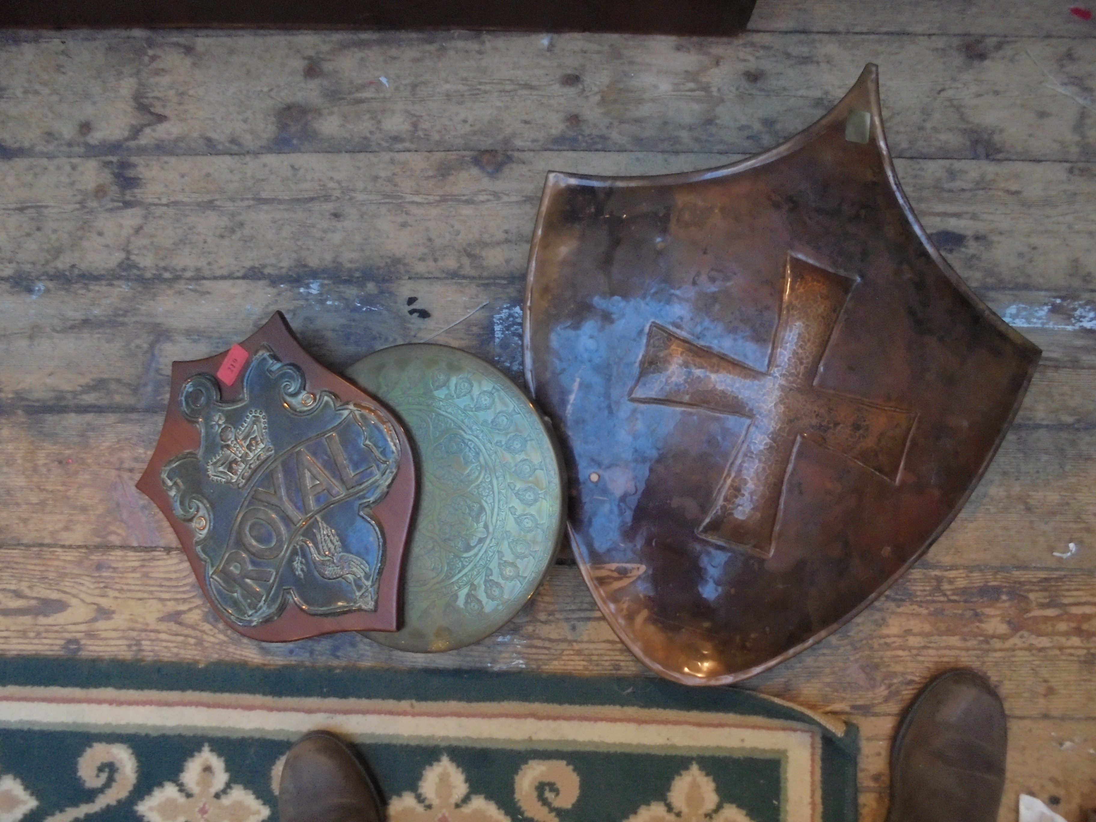 3 unusual items, one being a beaten copper shield,
