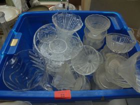 Crate containing a variety of glass sundae dishes, fruit bowls,