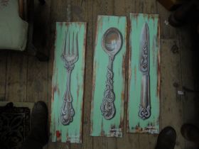 3 modern wall plaques showing a large knife,