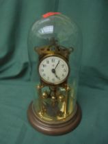 Glass domed table clock in brass on metal style base possible 1930's