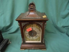 Large mantel clock in wood surround decorative top,