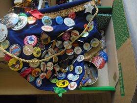 Large cloth banner which contains attached a huge number of vintage metal badges together with