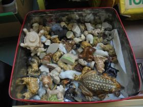 Tin containing a large number of miniature pottery animals,