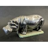 A car accessory mascot in the form of a hippopotamus, display base mounted, approx. 4 1/2" long.