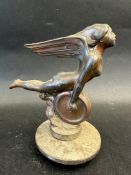 An Art Deco car mascot in form of a winged nude female holding a wheel, the base inscribed ''