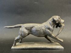 A car accessory mascot in the form of a labrador with game bird in mouth, approx. 6 1/2" long.