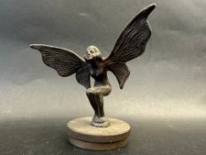 A car accessory mascot in the form of a crouching fairy, mounted on a radiator cap, approx. 4 3/4"