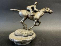 A Desmo car accessory mascot in the form of a horse and jockey, stamped to the base: Copyright, Made