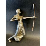 A car mascot in the form of a female archer knelt on her left knee, swathed from her waist in cloth,