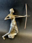 A car mascot in the form of a female archer knelt on her left knee, swathed from her waist in cloth,