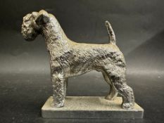 A car mascot in the form of an airedale terrier stamped to base: LL Mascots Made In England (Louis