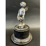 A car accessory mascot in the form of a cherub, display base mounted, approx 6" high overall.