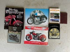A small quantity of motorcycle books and two reproduction signs.