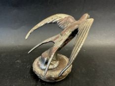 A car accessory mascot in the form of a swallow, mounted on a radiator cap, approx. 4 1/4" high