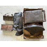 A quantity of vintage motorcycle seats, leather leggings and two leather tool boxes.