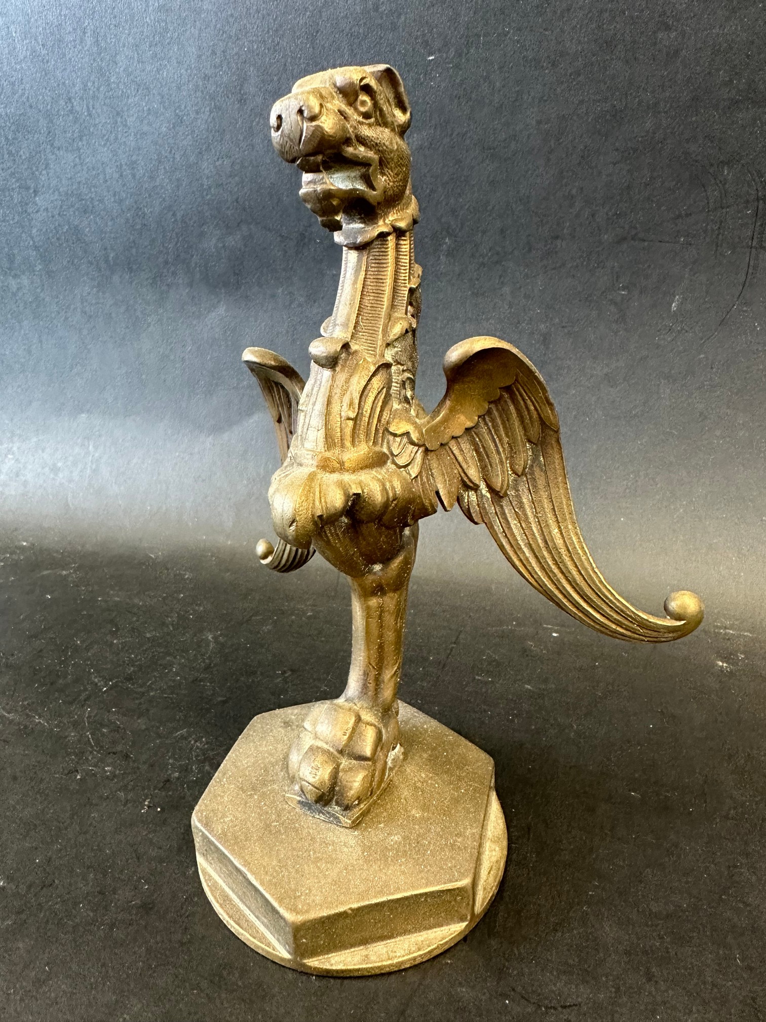 A well-detailed griffin car mascot, approx. 7" tall, radiator cap mounted.