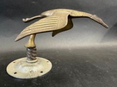 A brass accessory mascot in the form of a flying stork, display base mounted, overall approx. 5"