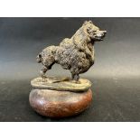 A well-detailed car accessory mascot in the form of a standing poodle, stamped to base: Finnigans,