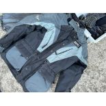 A quantity of motorcycle clothing including jackets, helmets (for display only), boots etc.