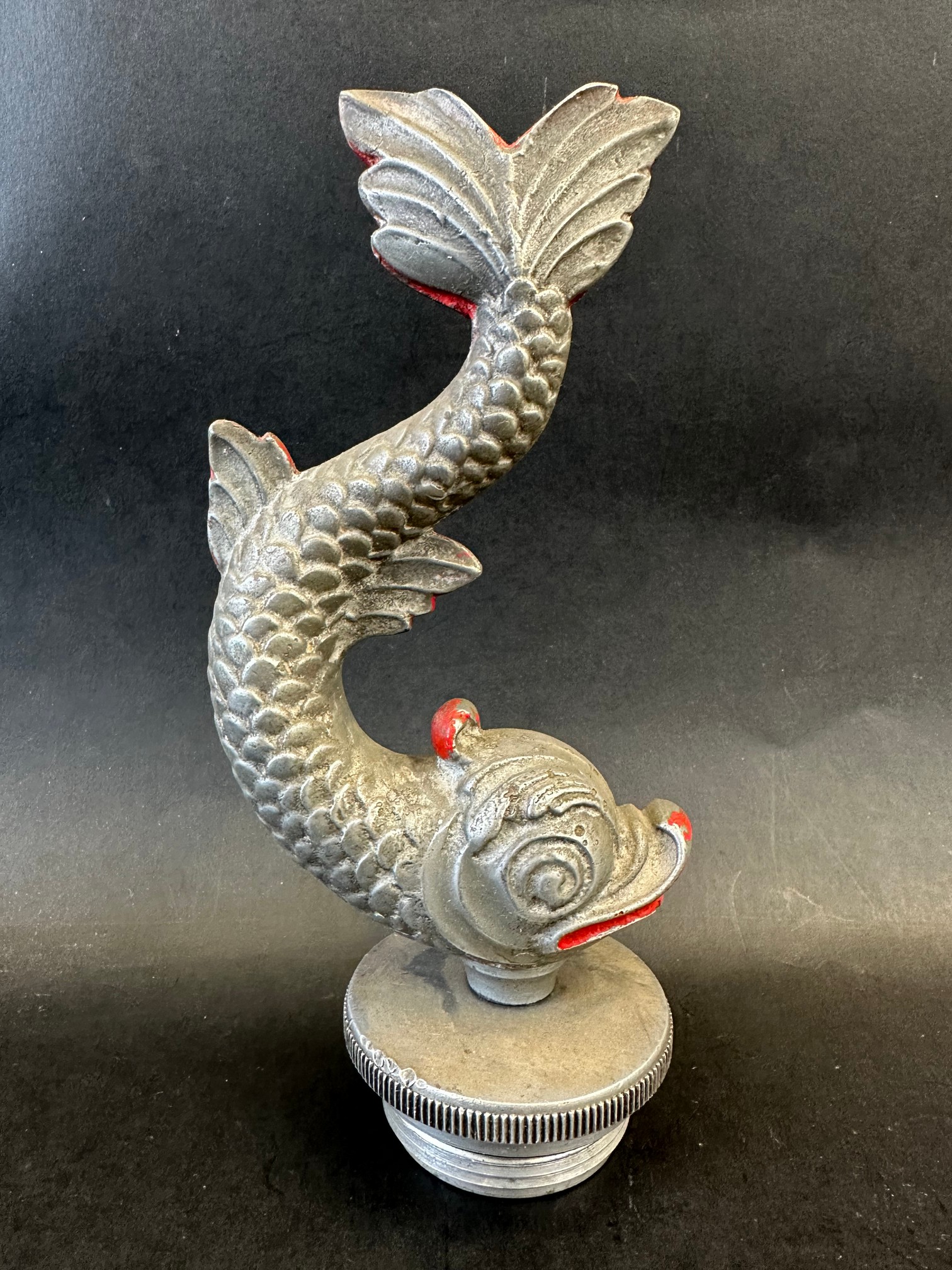 A car mascot in the form of a fish, radiator cap mounted, traces of red paint, approx. 8 1/4" high