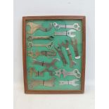 A framed and glazed dioramah display of bicycle tools.