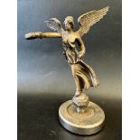 A car mascot in the form of Victory - angel holding out a laurel wreath, possibly missing trumpet,