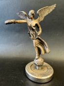 A car mascot in the form of Victory - angel holding out a laurel wreath, possibly missing trumpet,