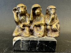 A brass Three Wise Monkeys 'Hear No Evil, See No Evil, Speak No Evil' car mascot depicting three