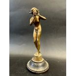 A brass car accessory mascot in the form of a female nude, inscribed to the base 'HELLO NYNFH R/