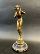 A brass car accessory mascot in the form of a female nude, inscribed to the base 'HELLO NYNFH R/