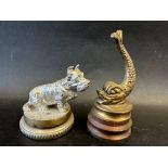 A car mascot in the form of a seated Scottie dog on display base, approx 3 1/2" wide and a fish on
