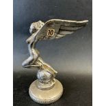 A car mascot in the form of a winged lady upon a globe, suited to a Triumph Gloria, display base