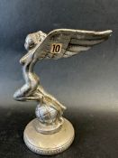 A car mascot in the form of a winged lady upon a globe, suited to a Triumph Gloria, display base