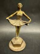 A brass car accessory mascot in the form of a ballerina on points, approx. 5 3/4" high.