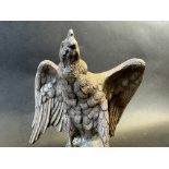 An incredibly heavy sculpture of an eagle upon a rock, well detailed, approx. 5" tall.