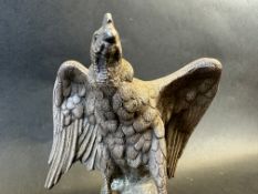 An incredibly heavy sculpture of an eagle upon a rock, well detailed, approx. 5" tall.