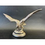 A car mascot in the form of an eagle/bird of prey with outstretched wings, very well detailed,