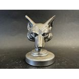 A car accessory mascot in the form of fox's head, display base mounted, approx. 3 1/2" high overall.