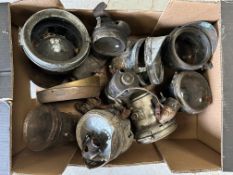 A box of carbide lights and producers, motorcycle and car related.