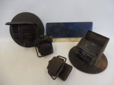 Two wartime headlamp diffusers , two bicycle lamps, similarly difused and an accessory sun visor.