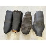 Four motorcycle seats, various.