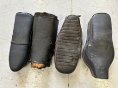 Four motorcycle seats, various.