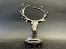 A car accessory mascot in the form of a stag's head mounted on a radiator cap, approx. 5 1/4" high.